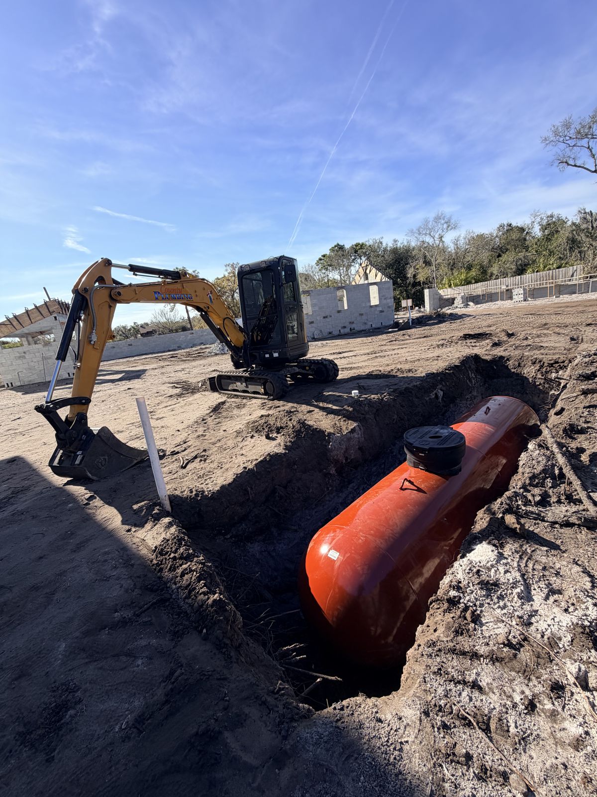 Burying a propane tank with the excavator